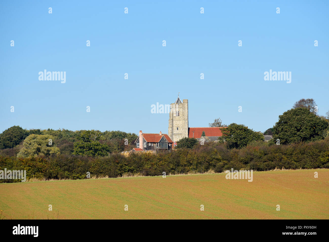 All Saints Church, Rettendon, Essex, UK. English countryside with field, hedges and trees. Blue sky with copyspace Stock Photo