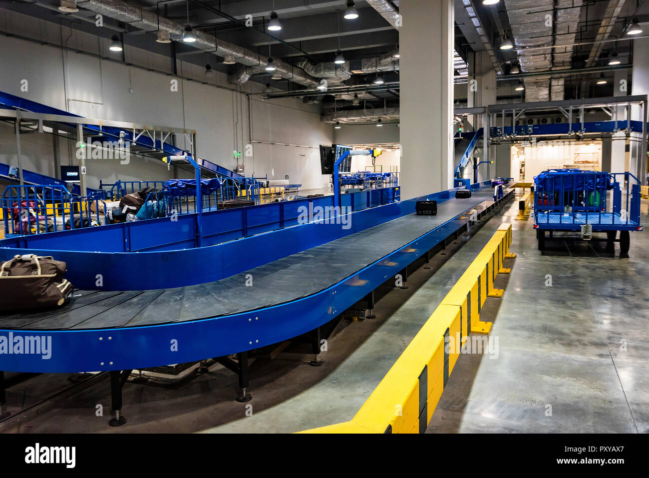 Baggage claim area with baggage carousels and carts Stock Photo