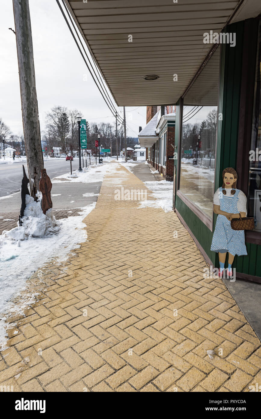 Wood cutout of Dorothy guards The home of L. Frank Baum, author of The Wizard of Oz books, in Chittenango, New York. Stock Photo