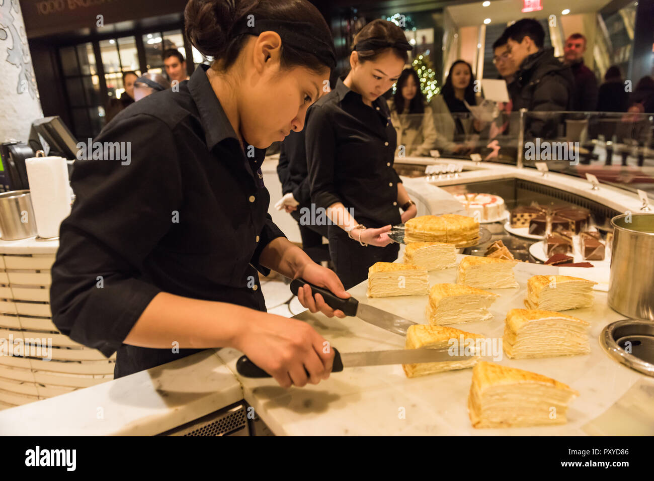 Waitress serves up Mille Crepe Cake in New York City. Stock Photo