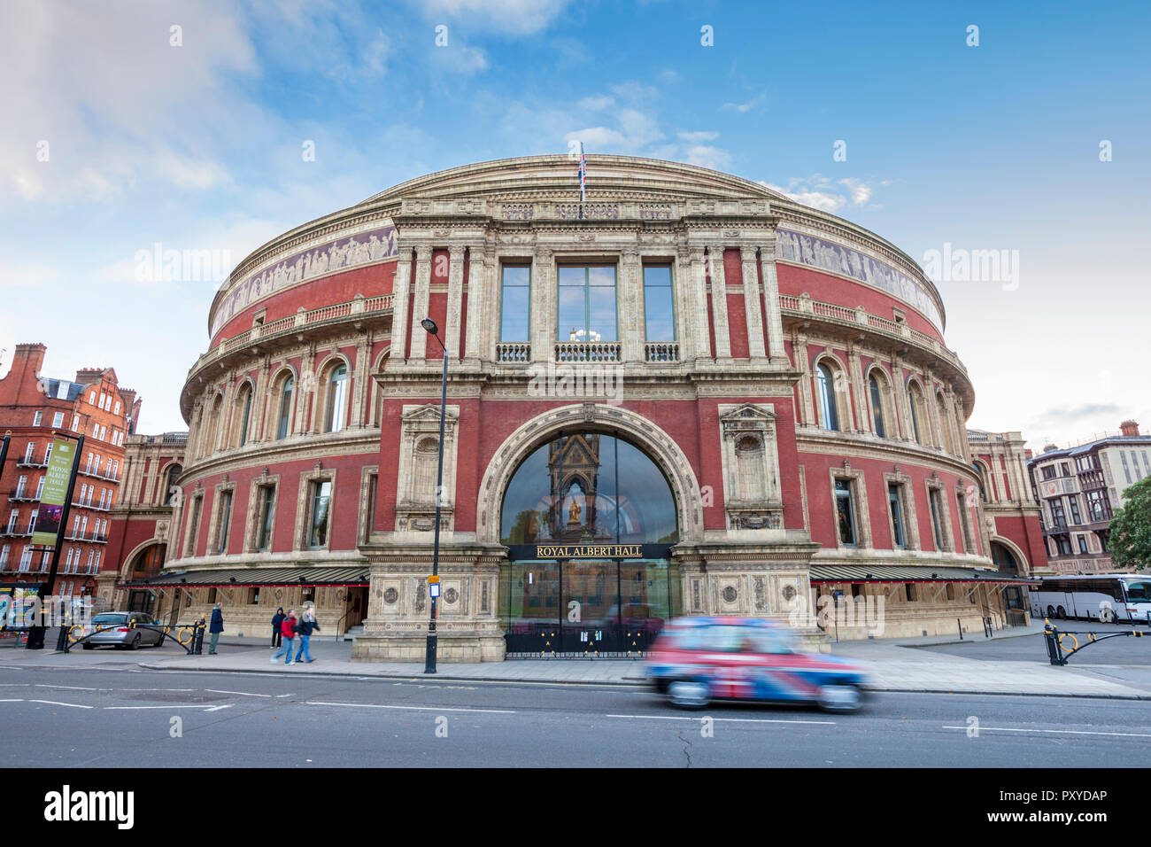 A Union Jack decorated London Taxi moving passed the Royal Albert Hall London, England Stock Photo