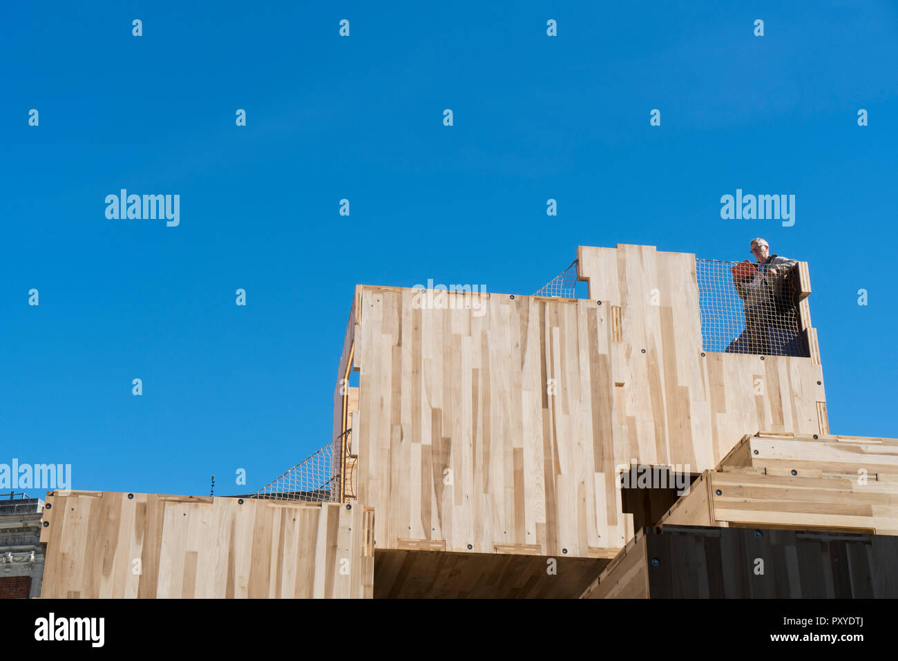 a man standing on the Multiply at V&A Museum. It is a temporary maze-like structure that highlights world problems of climate change and housing need Stock Photo