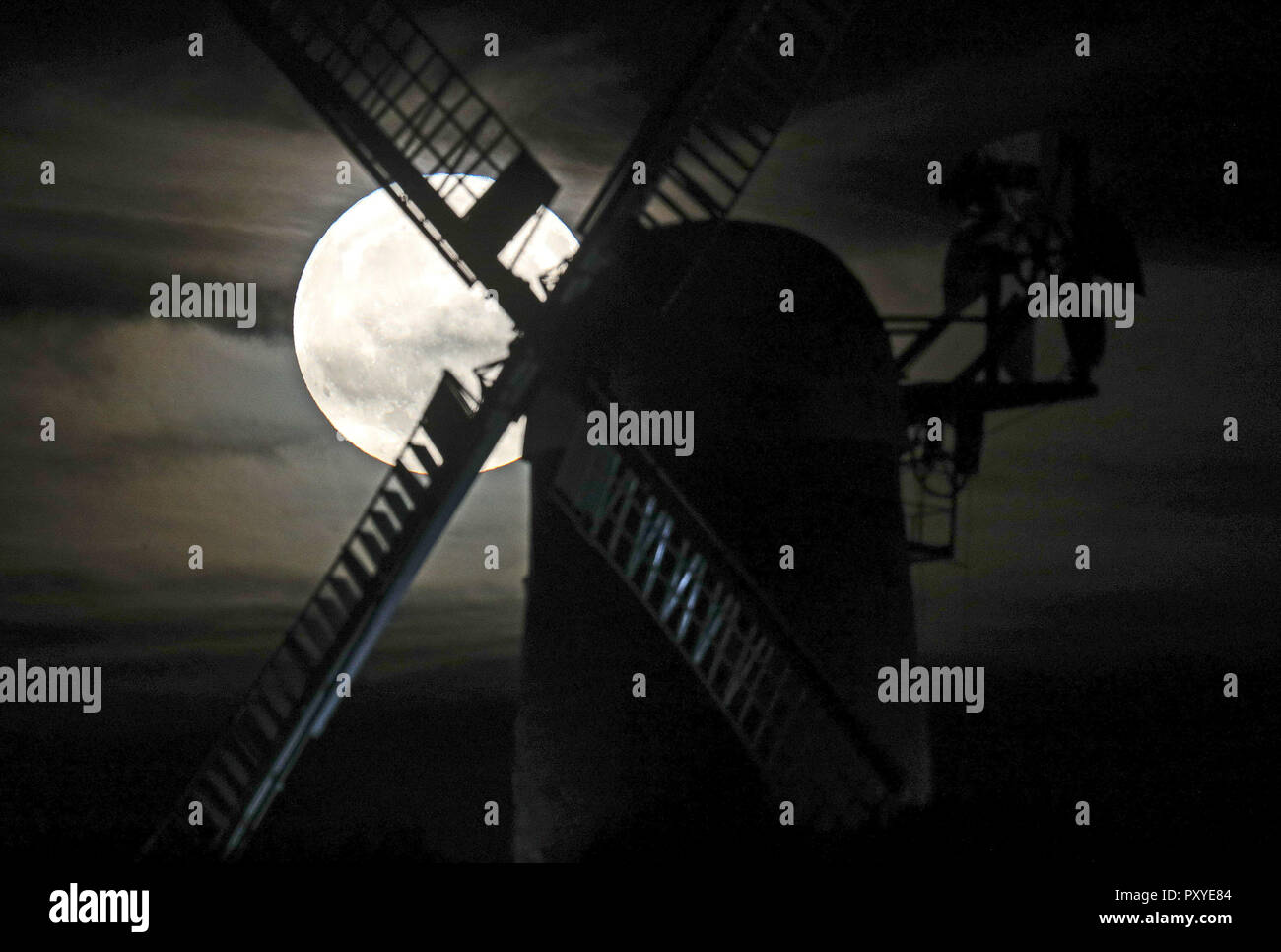 A near full Hunter's moon rises behind Wilton Windmill in Wiltshire. Stock Photo
