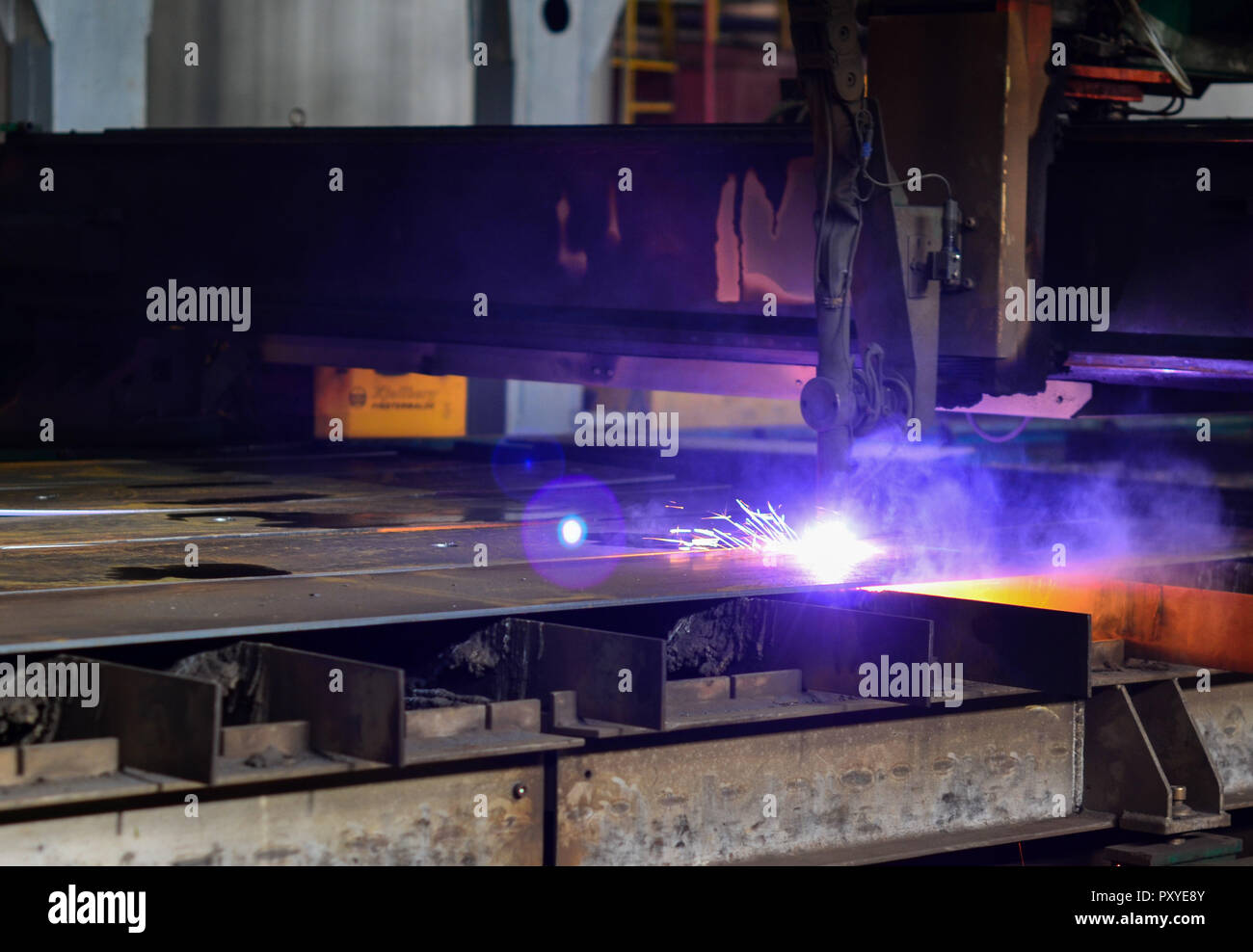 Cutting metal with plasma equipment. Worker cutting steel pipe using