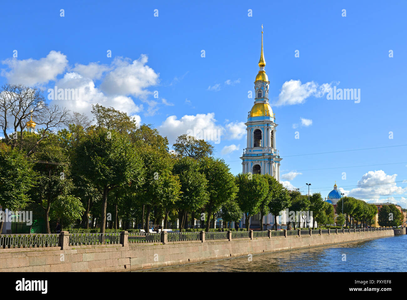 Four story bell tower with tall gilded spire (1755–1758) of St. Nicholas Cathedral and garden. Saint Petersburg, Russia Stock Photo