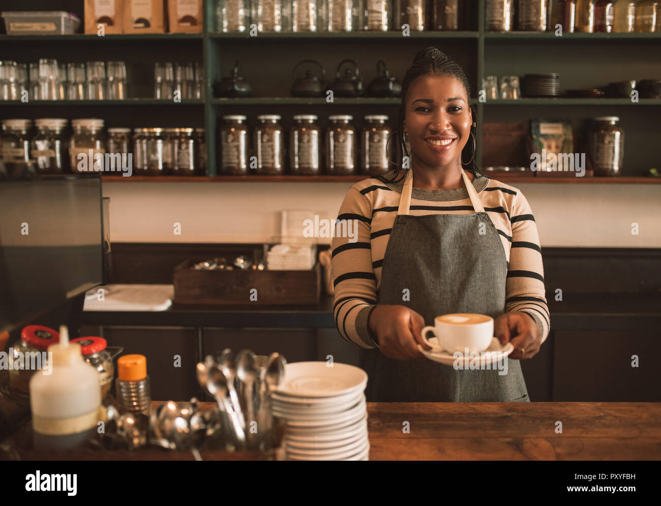 Smiling cafe owner in apron hi-res stock photography and images - Alamy