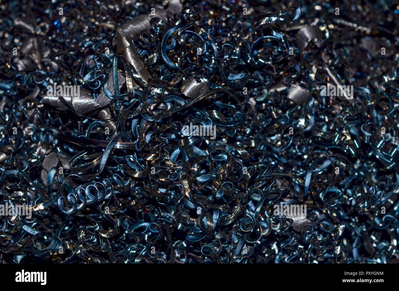 Recycling scrap metal amid metal shavings. Industrial production ...