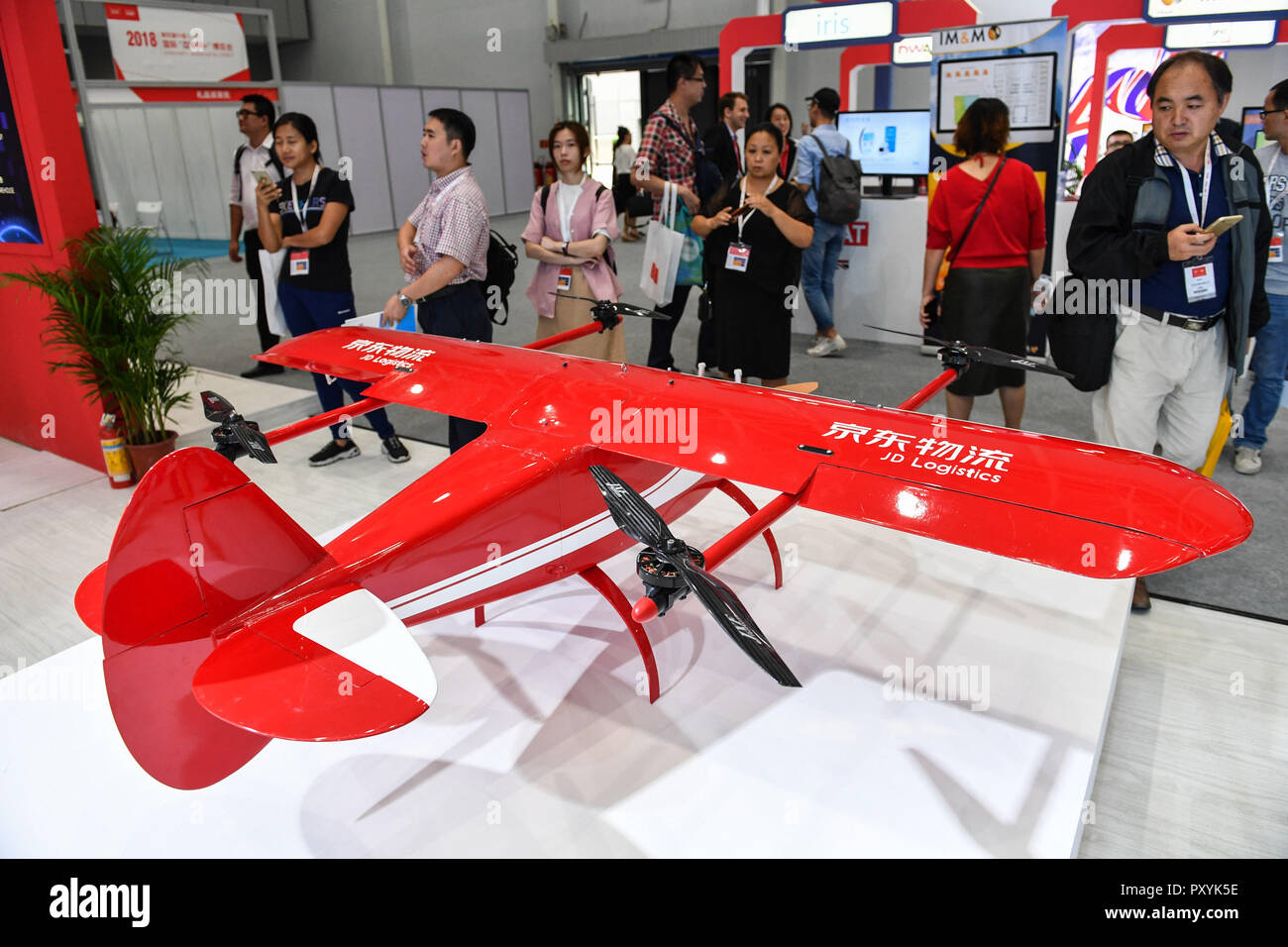 Shunde, China's Guangdong Province. 24th Oct, 2018. Visitors look at a hybrid power drone for e-commerce delivery during the Internet  Expo at Shunde District of Foshan, south China's Guangdong Province, Oct. 24, 2018. The 4th Internet  Expo kicked off here on Wednesday. This year's expo consists of six major parts, respectively 'Internet Plus' Frontier Technology, Digital Business, Digital Life, Innovation and Startups, Robotics and Intelligent Manufacturing and Robots. The expo brings together more than 650 companies from around the world. Credit: Lu Ye/Xinhua/Alamy Live News Stock Photo