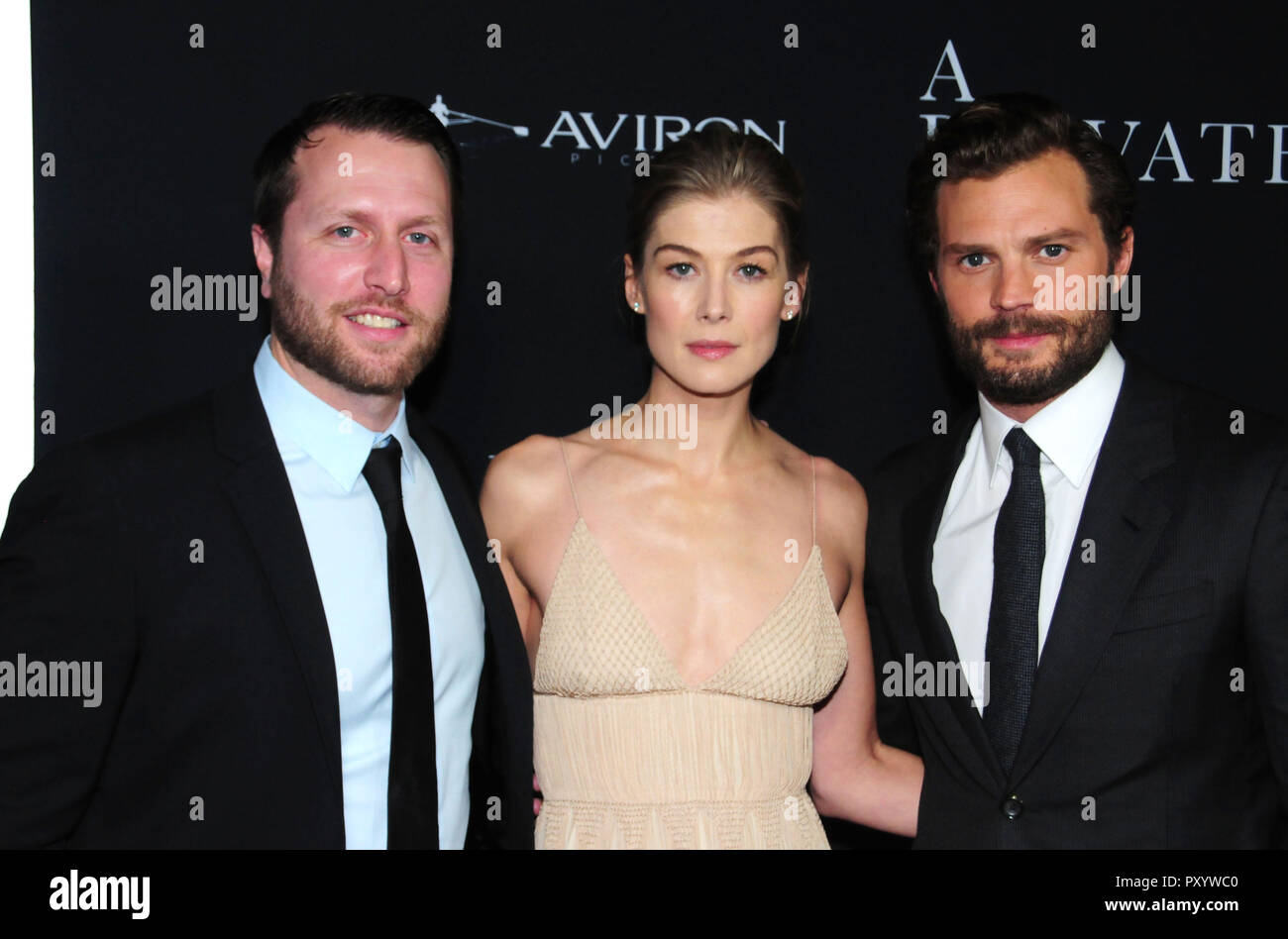 Beverly Hills, California, USA. 24th October, 2018. Director Matthew Heineman, actress Rosamund Pike and actor Jamie Dornan attend the Los Angeles Premiere of Aviron Pictures' 'A Private War' at Samuel Goldwyn Theater in Beverly Hills, California. Photo by Barry King/Alamy Live News Stock Photo