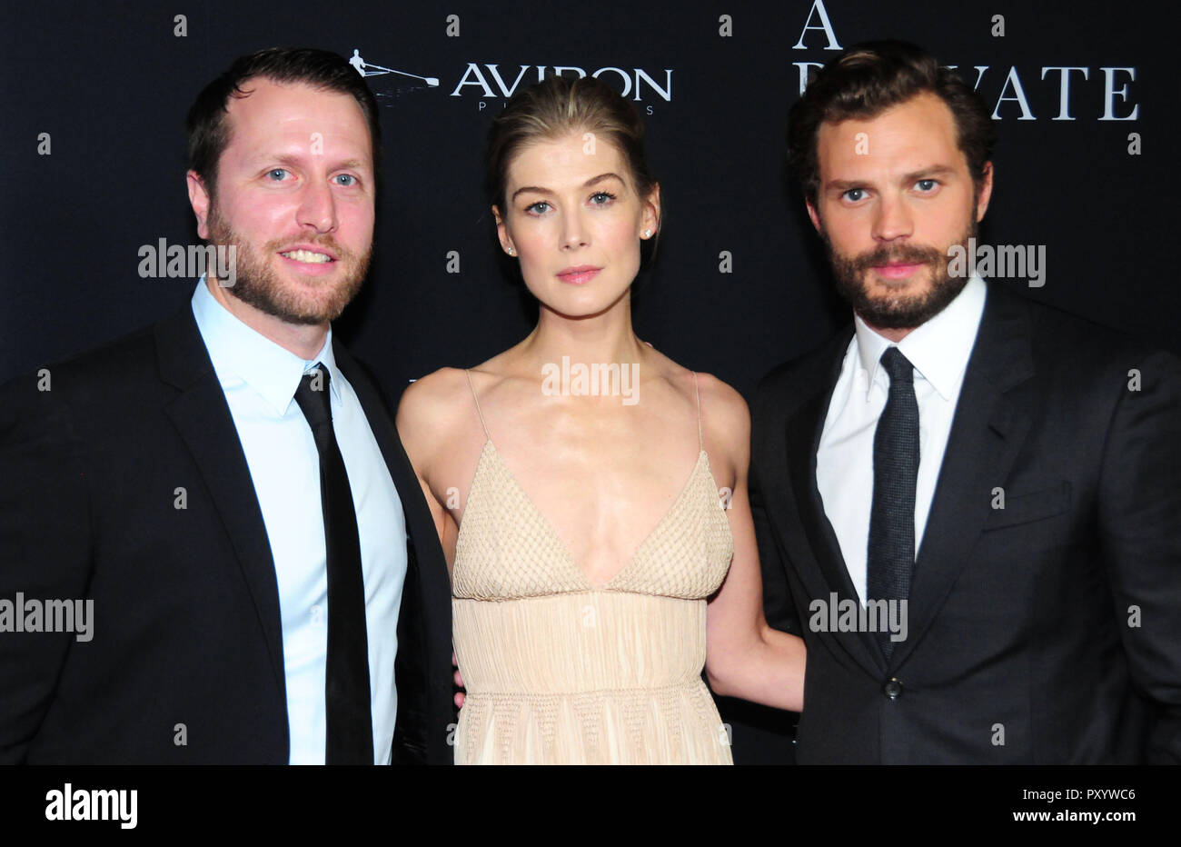 Beverly Hills, California, USA. 24th October, 2018. Director Matthew Heineman, actress Rosamund Pike and actor Jamie Dornan attend the Los Angeles Premiere of Aviron Pictures' 'A Private War' at Samuel Goldwyn Theater in Beverly Hills, California. Photo by Barry King/Alamy Live News Stock Photo