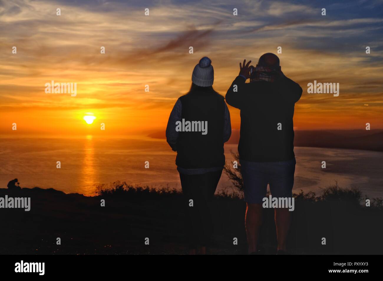 Golden Cap, Dorset, UK - 24 October 2018. Visitors to Golden Cap, the highest point on the south coast, enjoy a glorious sunset as the almost spring like weather continues in the south west. Credit: Tom Corban/Alamy Live News Stock Photo