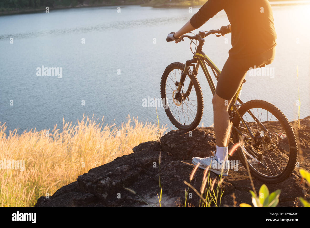 Cyclist on the mountain top of lake, Extreme and adventure life. Stock Photo