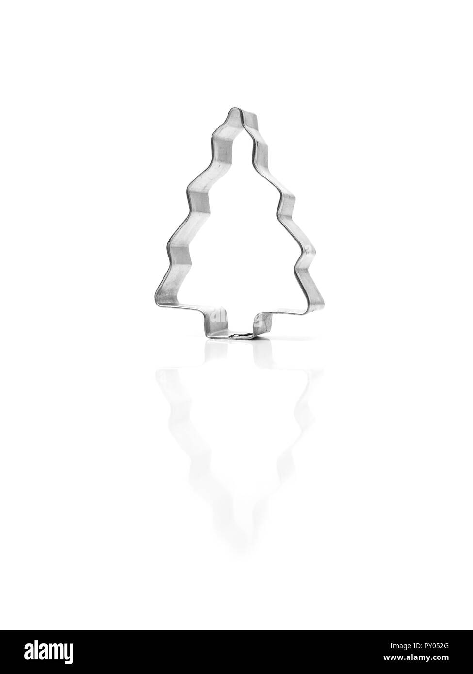 Tree shaped baking tin with reflections on a white background, puristic