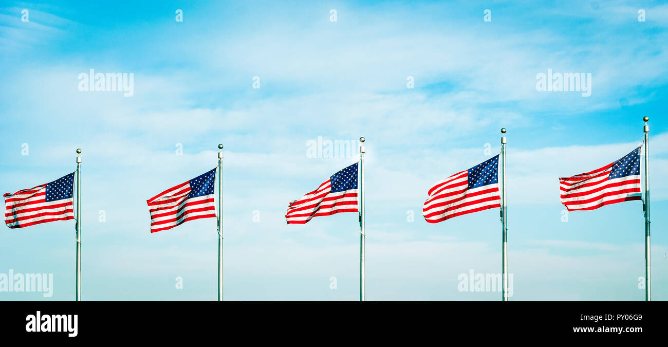 Group of five American flags waving in the wind. Patriotic concept Stock Photo
