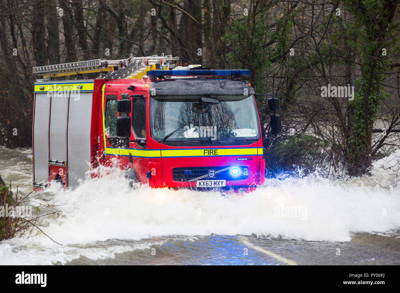 A fire engine going through flood waters on the Ambleside, Coniston road at Rothay bridge in the Lake District on Saturday 5th December 2015, during torrential rain from storm Desmond. Stock Photo