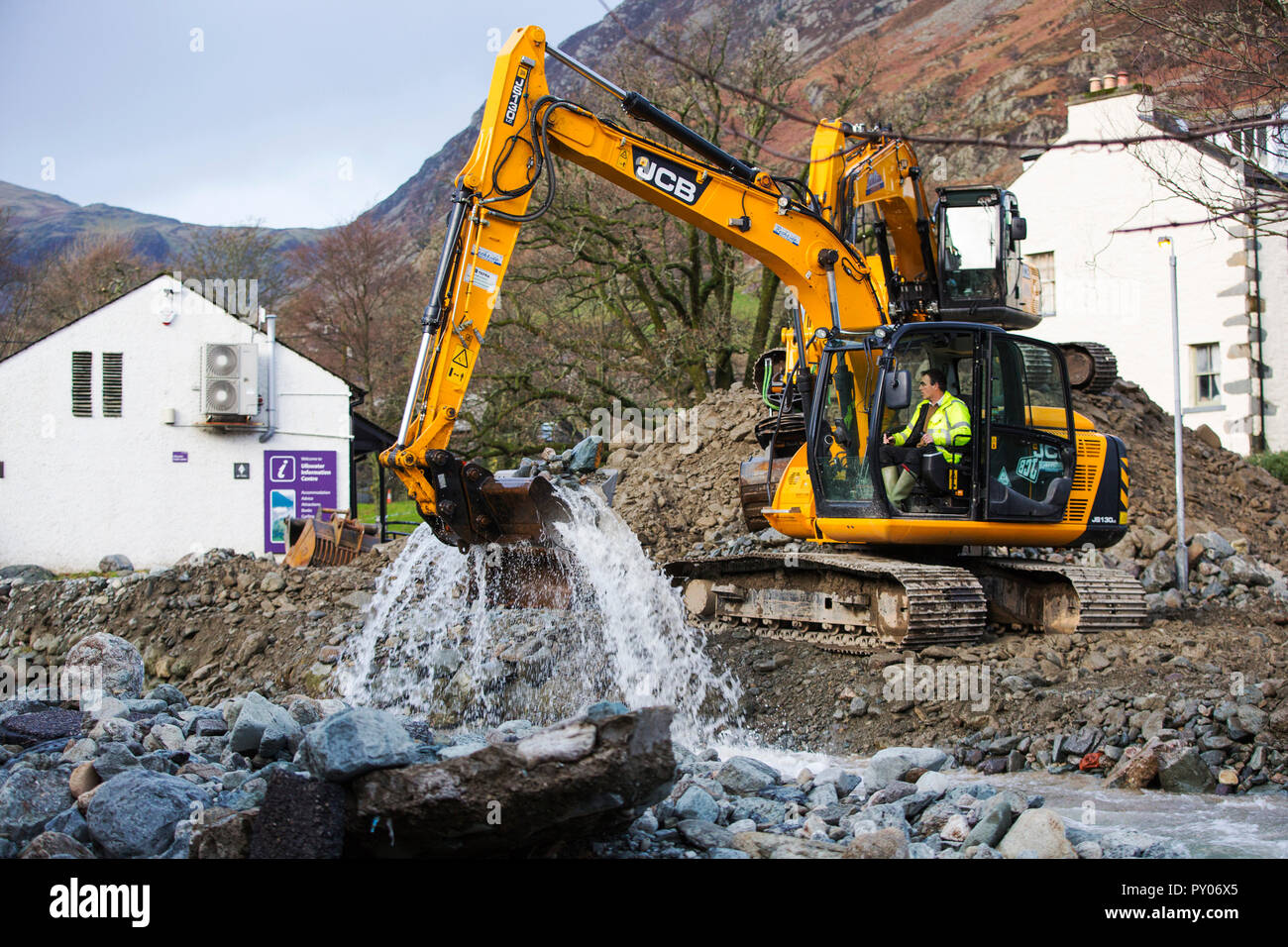 On Saturday 5th December 2015, Storm desmond crashed into the UK, producing the UK''s highest ever 24 hour rainfall total at 341.4mm. It flooded the Lakeland village Glenridding, which was just starting to repair when another period of heavy rain on Wednesday 9th December caused the Glenridding Beck to burst its banks, causing yet further destruction. This picture taken the next morning on Thursday 10th December of diggers trying to clear flood debris from the river.' Stock Photo