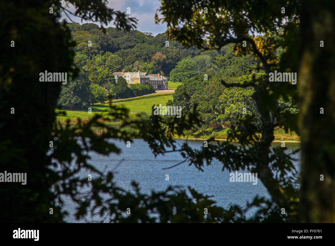 Penrose House seen through the trees at The Loe or Loe Pool, Cornwall's largest natural lake