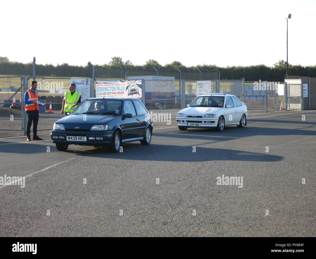 Ford fiesta mk3 rs turbo and escort rs2000 shown at donnington park race circuit at the RS owners club national day - entering show ground with ticket marshall Stock Photo