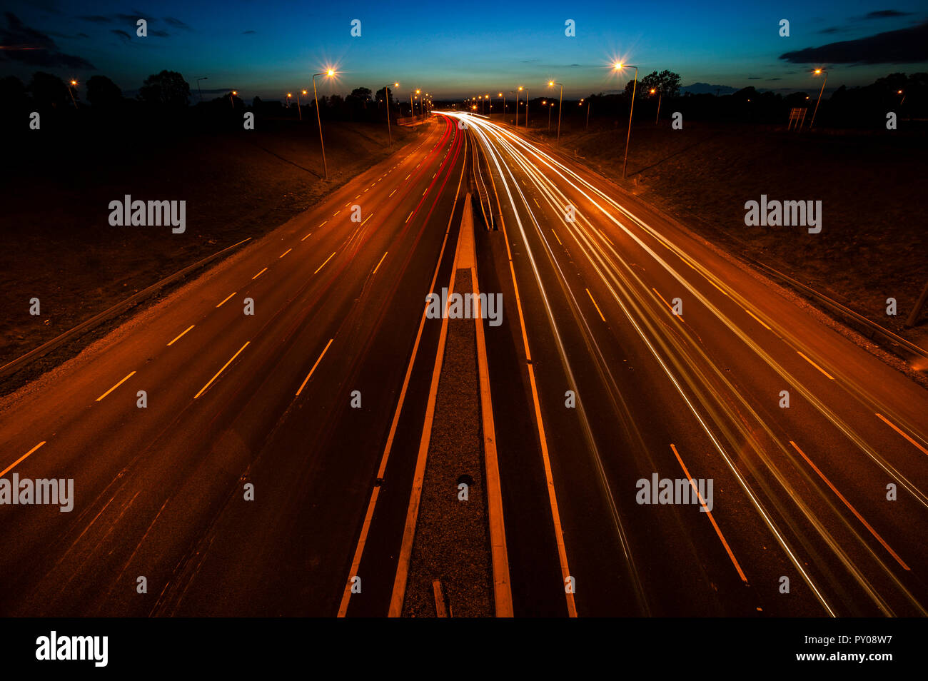 Motorway traffic at night, light blur Stock Photo