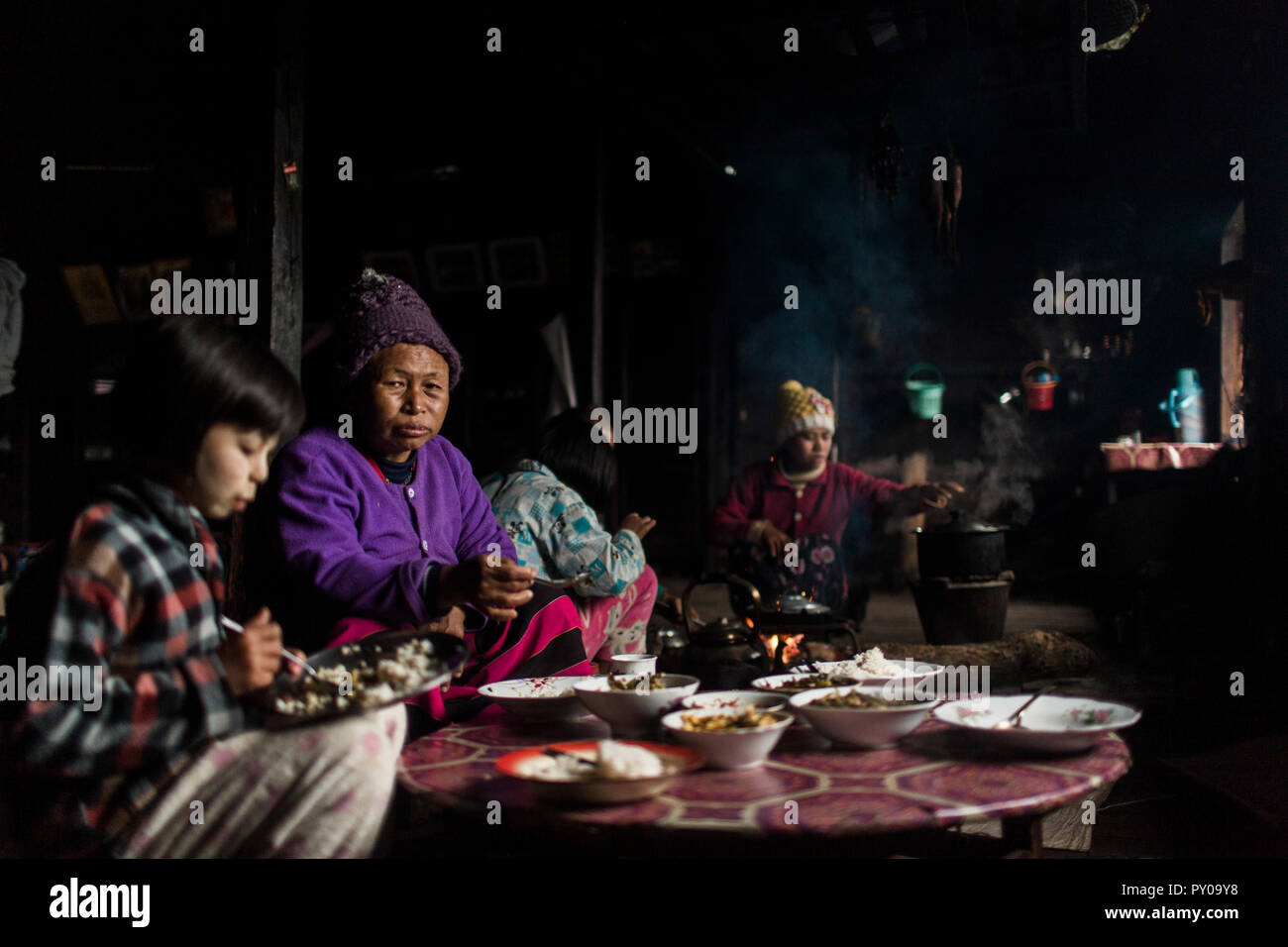 Three generation family eating together in small rural house, Myanmar, Shan, Myanmar Stock Photo