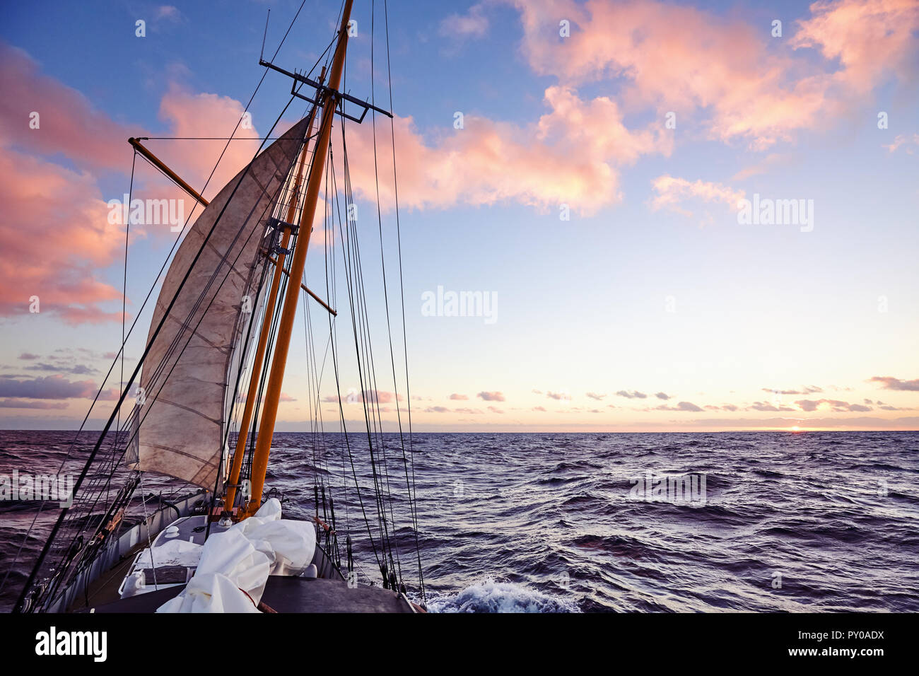 Old sailing ship mast at sunset, travel and adventure concept, color toned picture. Stock Photo
