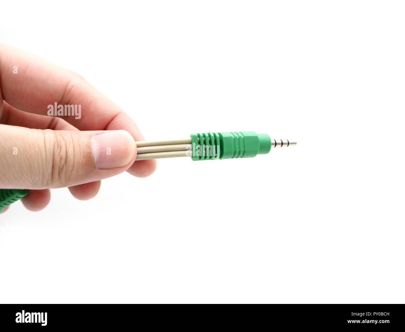 Hand holding a jack instrument cable isolated on a white background. Stock Photo