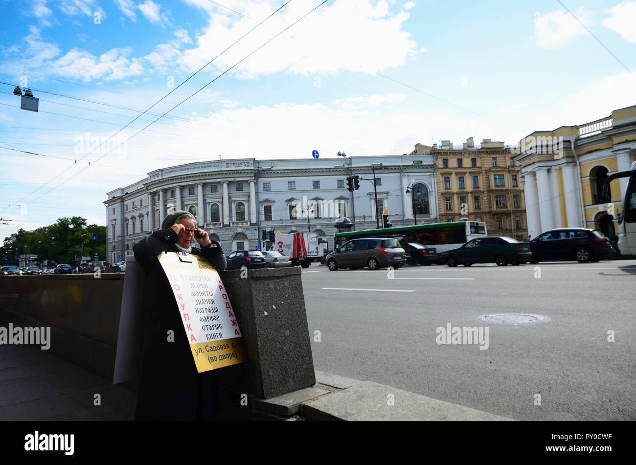 An older woman with advertising at the entrance of the subway. Nevsky Prospect is the main street in the city of St. Petersburg, Russia, named after t Stock Photo