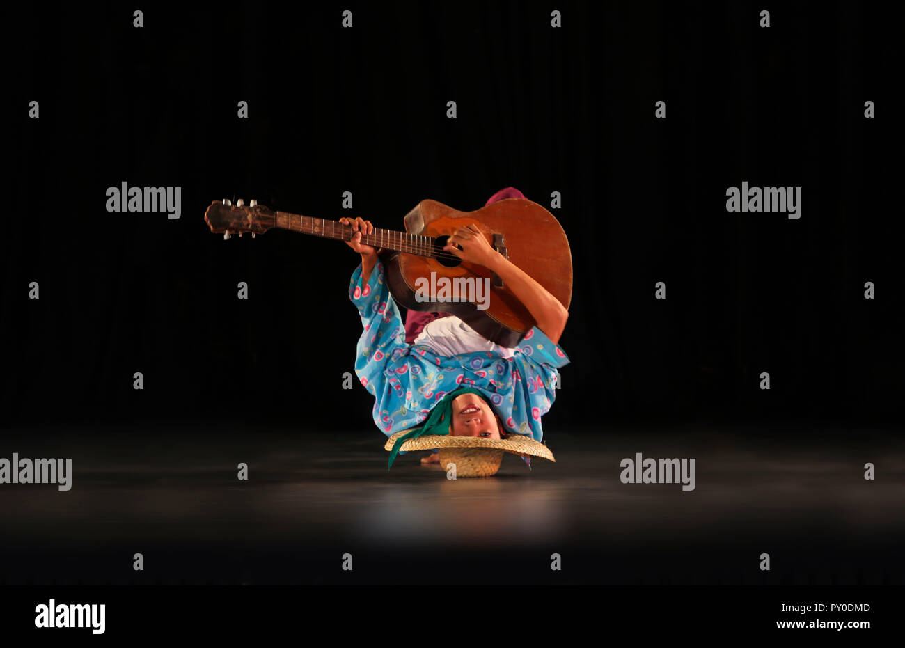 Guitar player upside down on stage, Villa Escudero, Manila, Luzon Island, Philippines Stock Photo