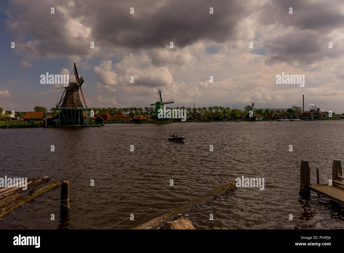 Netherlands, Zaanse Schans, windmills next to a body of water Stock Photo