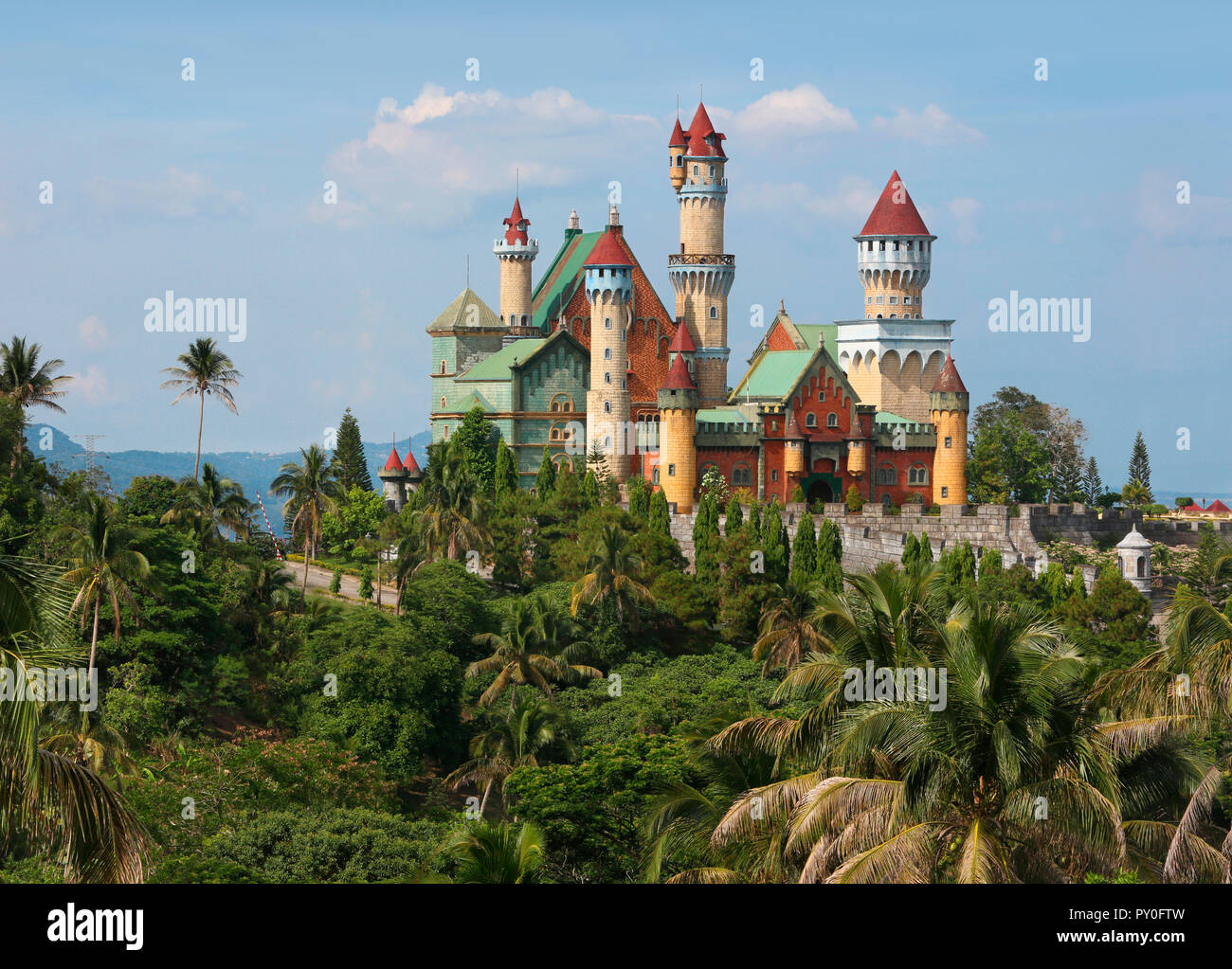Palm trees in front of Fantasy World castle in Lemery, Tagaytay, Batangas, Philippines Stock Photo