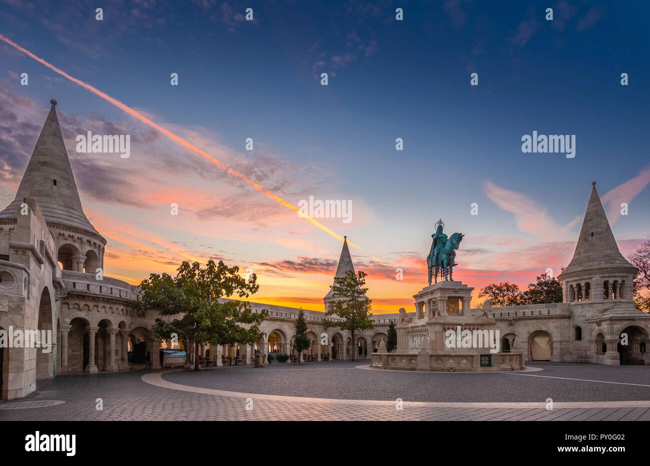 Budapest, Hungary - Fisherman's Bastion (Halaszbastya) and statue of Stephen I. with colorful sky and clouds at sunrise Stock Photo