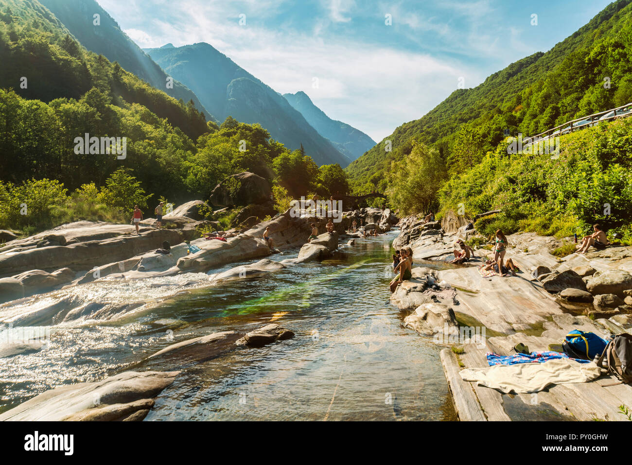 Mountainscape with forest and climbers relaxing near river, Â Valle Verzasca, Â Ticino, Switzerland Stock Photo