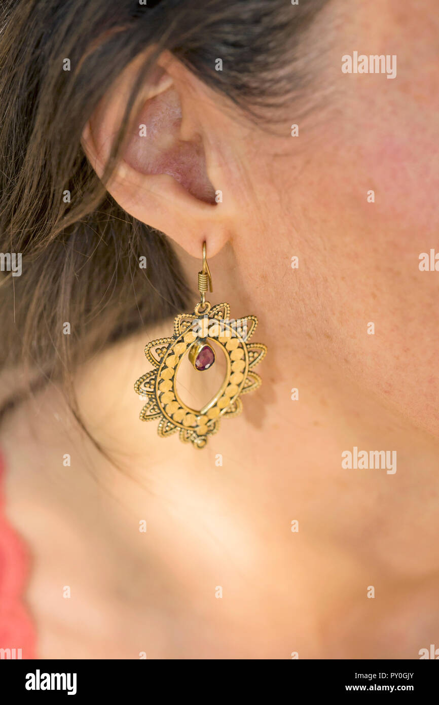 Brass earring with ruby stone drop Stock Photo