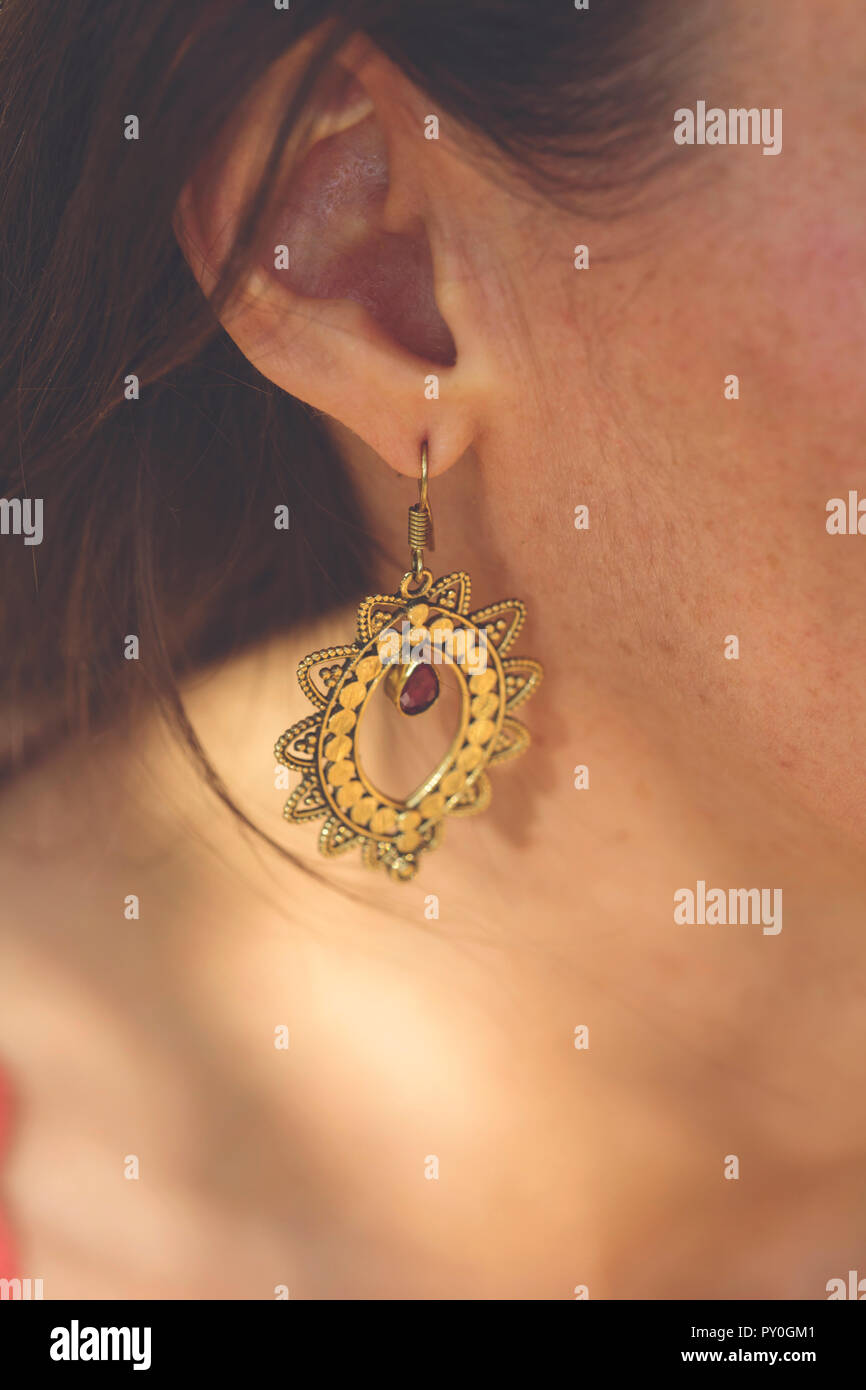 Brass earring with ruby stone drop Stock Photo