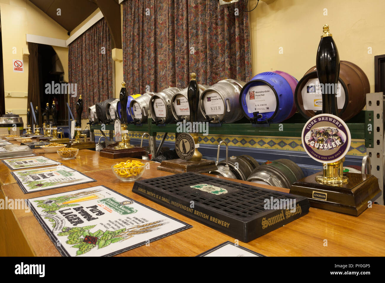Bar with casks of real ale behind, ready for the start of Boston Spa beer festival Stock Photo