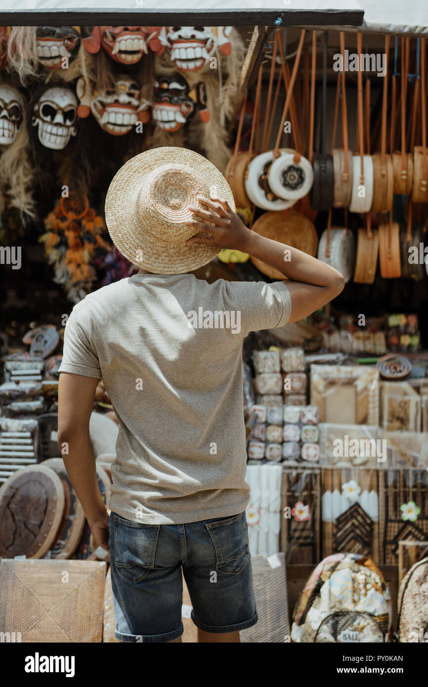 male tourist try to buy something in souvenir shop  Stock Photo