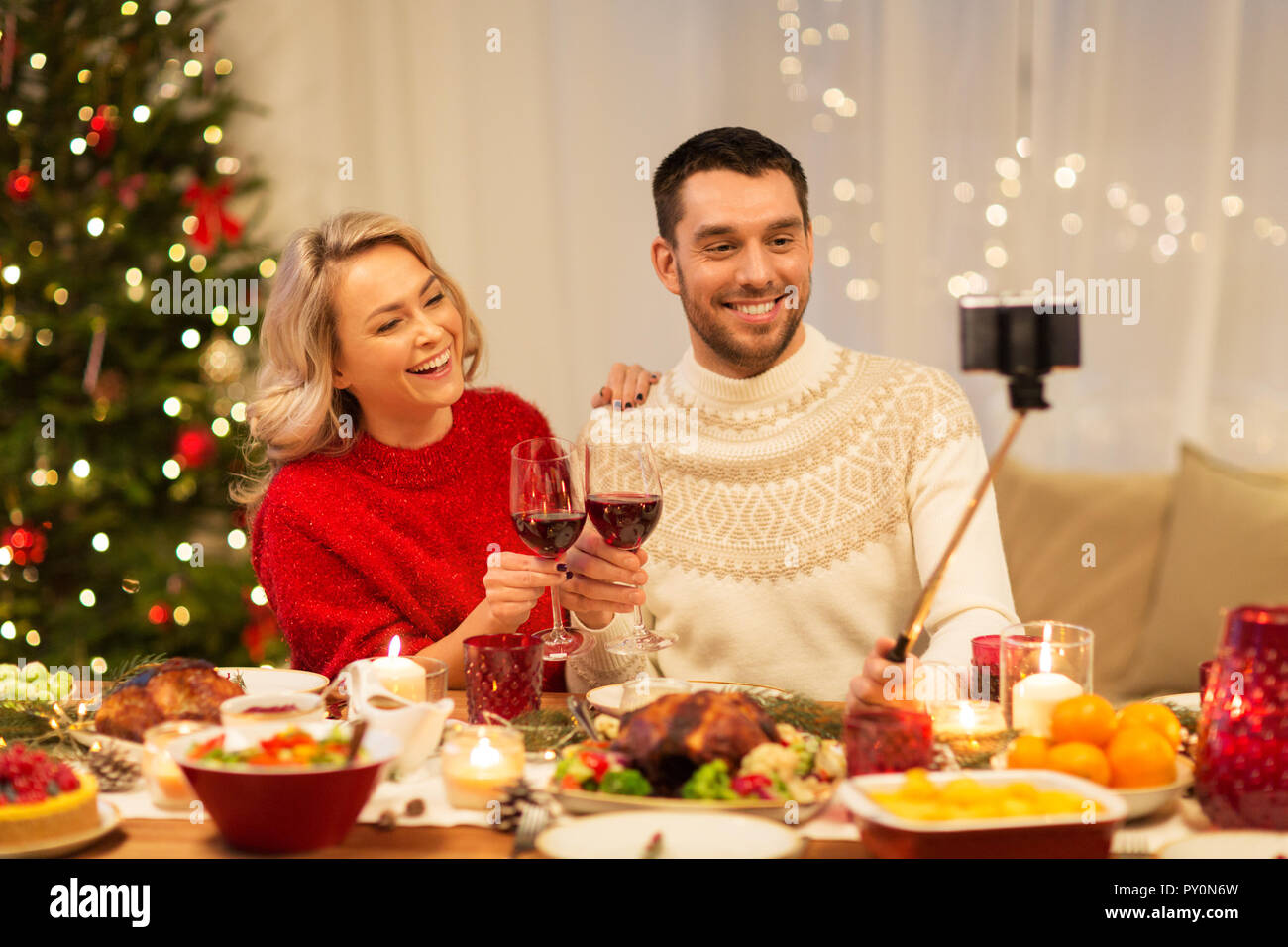 happy couple taking selfie at christmas dinner Stock Photo