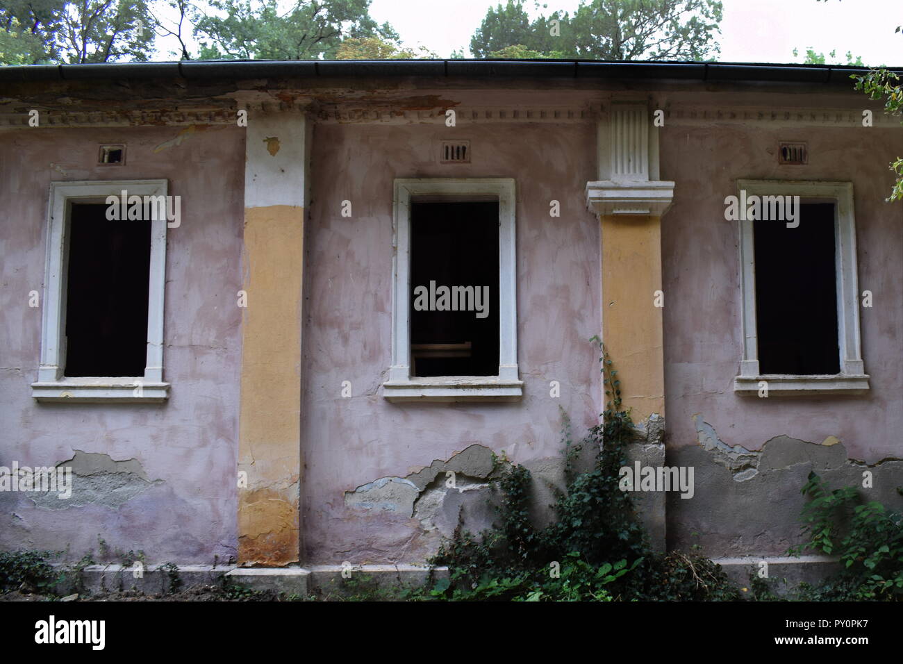 Three windows in an abandoned building Stock Photo