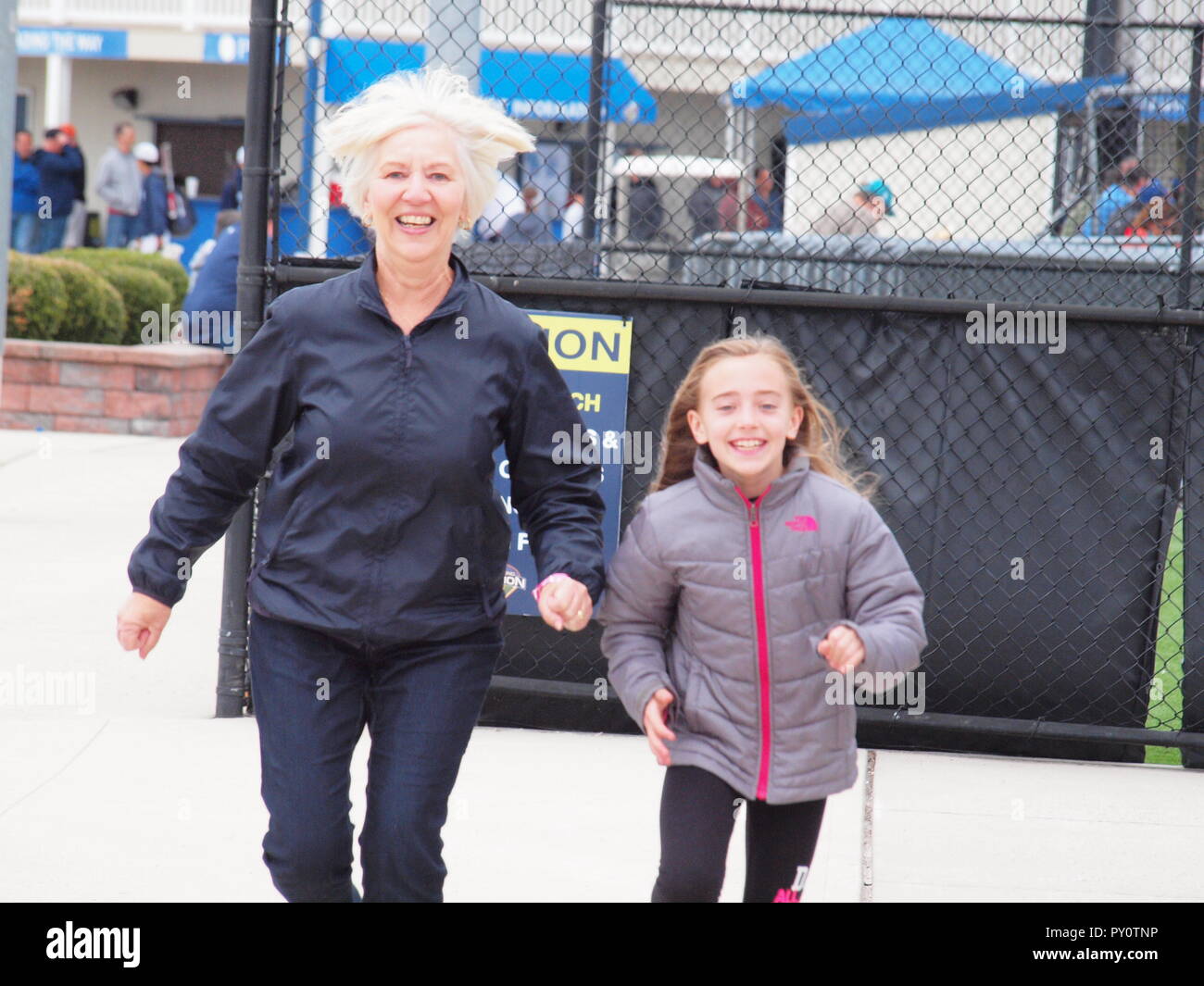 Grand daughter and grandmother running together having fun. Stock Photo