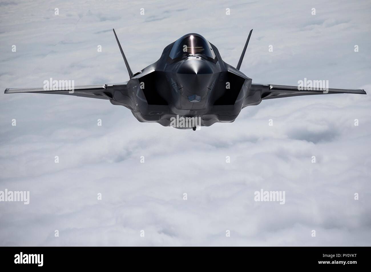 A U.S. Marine Corps F-35B Lightning II stealth fighter aircraft approaches a KC-130J tanker aircraft during an aerial refueling October 23, 2018 above the East China Sea. Stock Photo