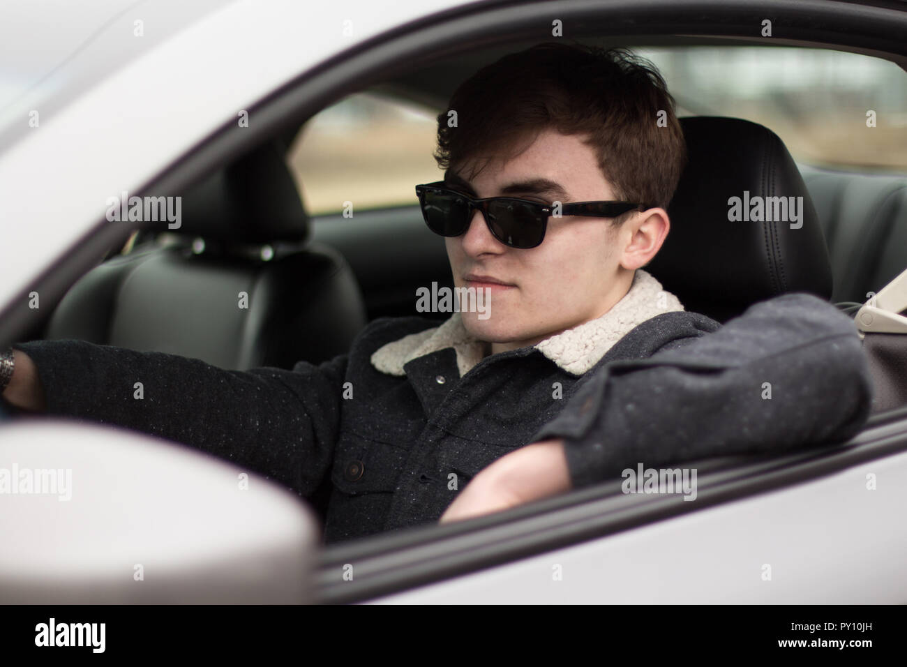 Man wearing sunglasses driving a car Stock Photo Alamy