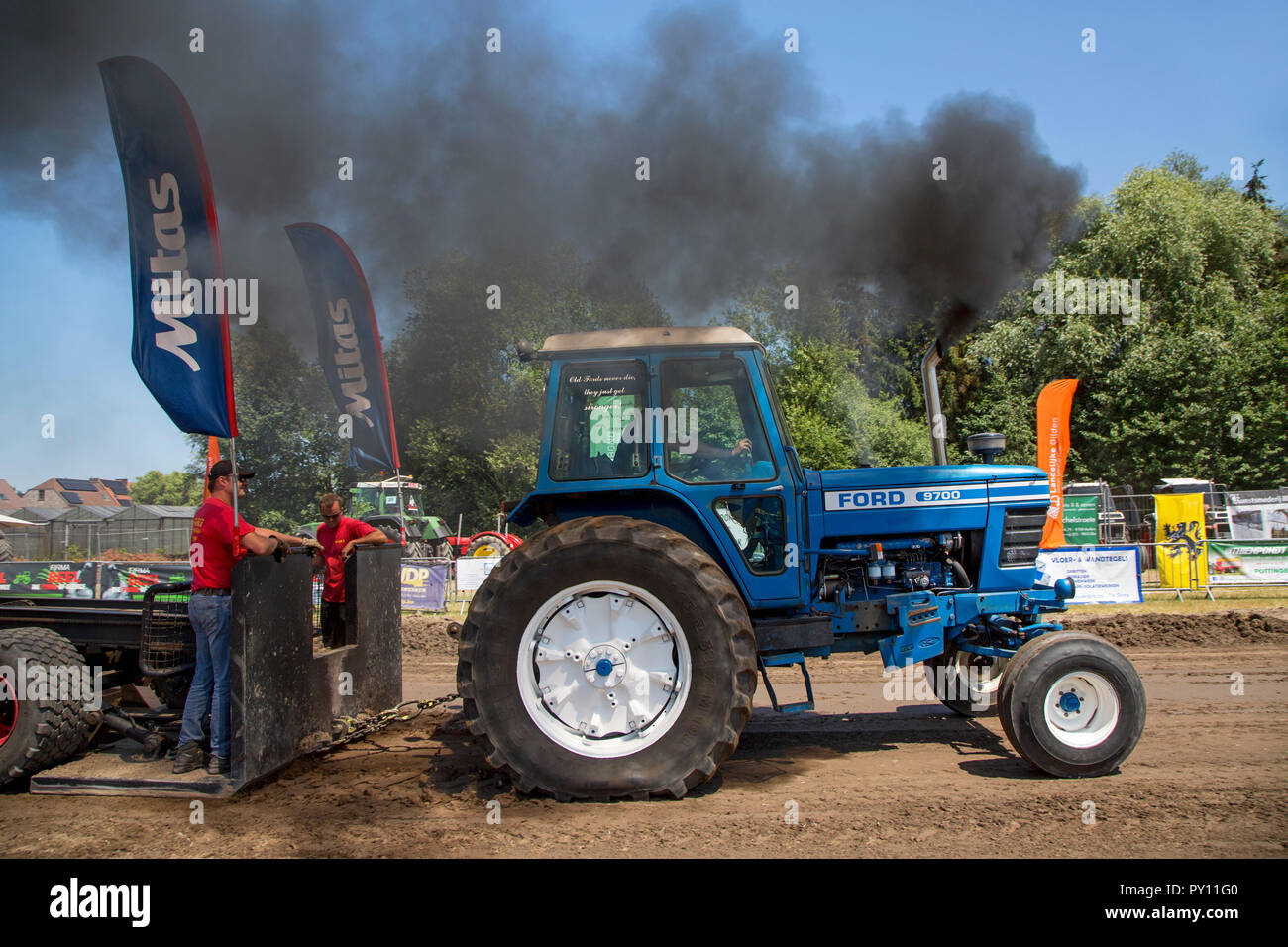 Non-modified diesel tractor Ford 9700 pulling heavy sled at Trekkertrek, tractor pulling competition in Zevergem, Flanders, Belgium Stock Photo