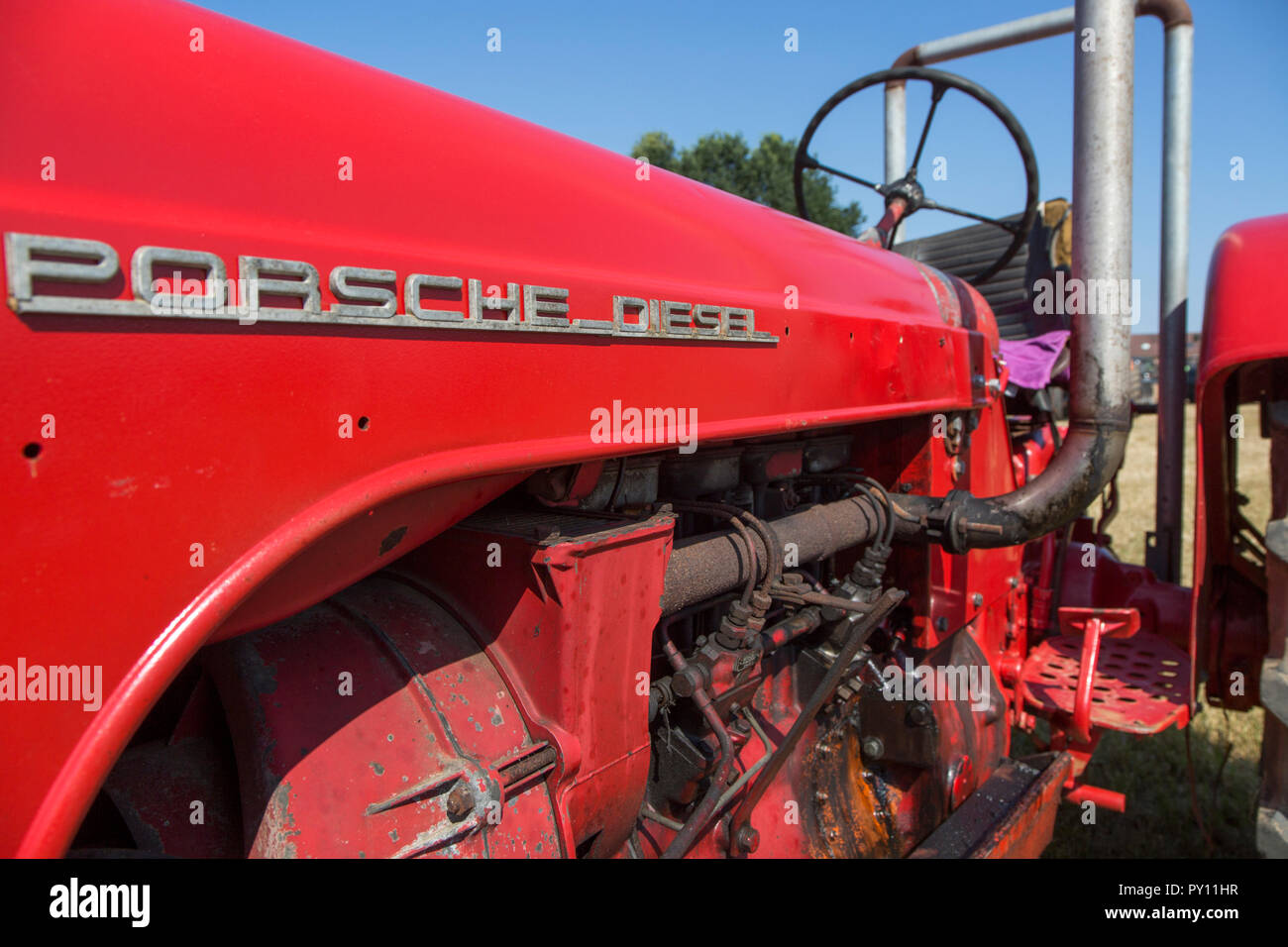 Close-up of oldtimer diesel engine of red Porsche Master tractor Stock Photo