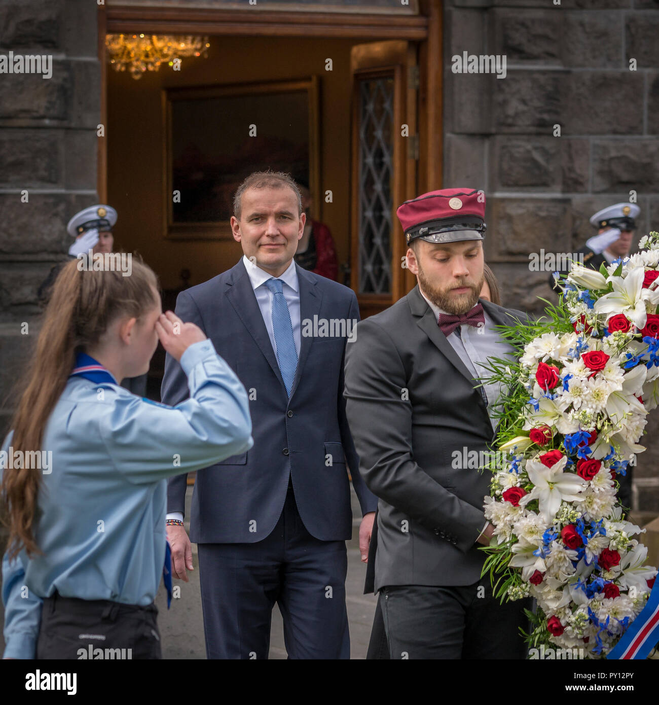 Girl scout salutes the president of Iceland, Gudni Th. Johannesson while a wreath is carried to the statue of Jon Sigurdsson, Iceland's independence d Stock Photo