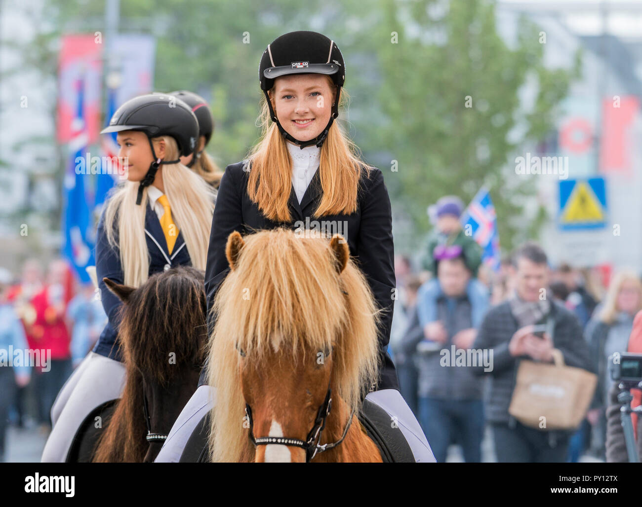 Young girls on horseback, during Iceland's independence day, Reykjavik, Iceland Stock Photo