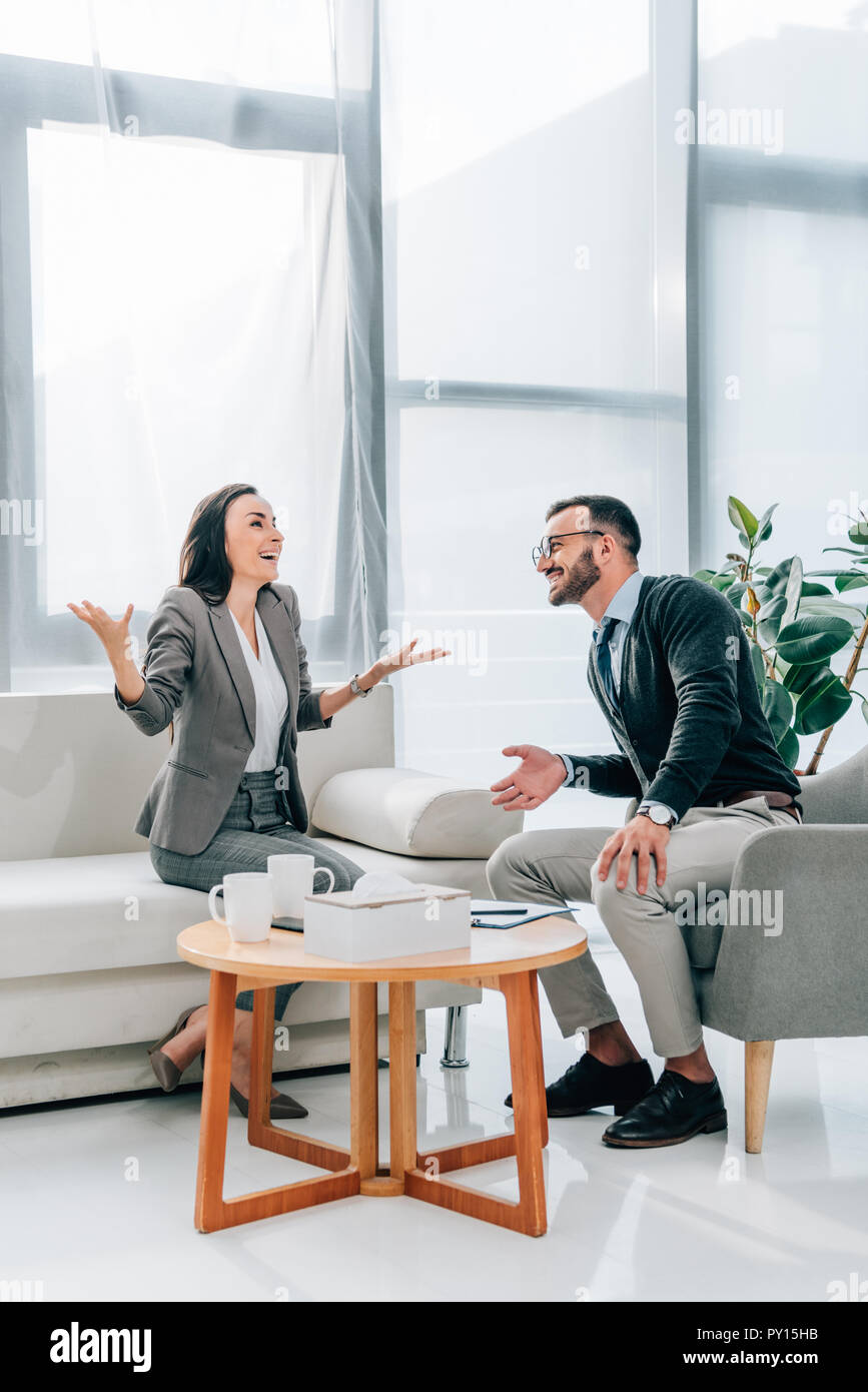 Happy Patient Gesturing In Psychologist Office Stock Photo