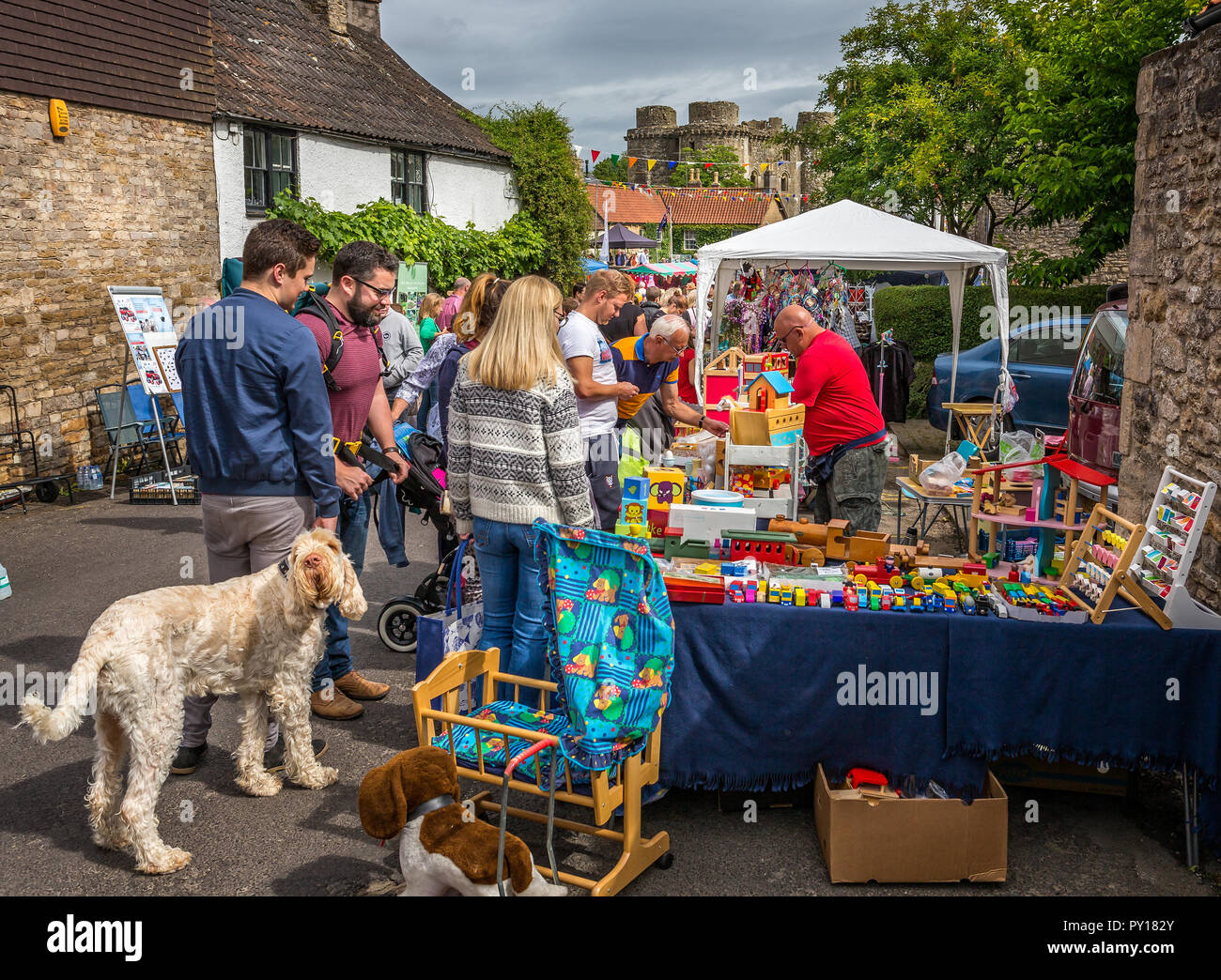 Crowds shopping at street stalls during Nunney Fayre in Nunney, Somerset, UK on 1 August 2015 Stock Photo