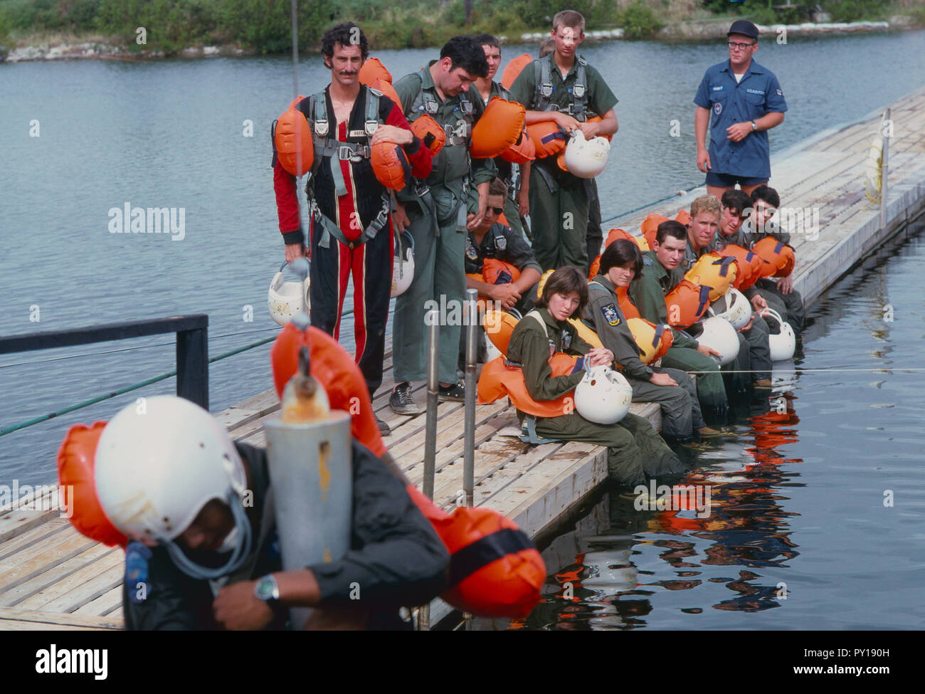 The first female NASA astronauts qualify in Water Survival School at Turkey Point, Florida. Here NASA astronaut candidates Anna L. Fisher and Sally Ride sit among their male classmates as they await their turn in a helicopter water pickup exercise. Stock Photo