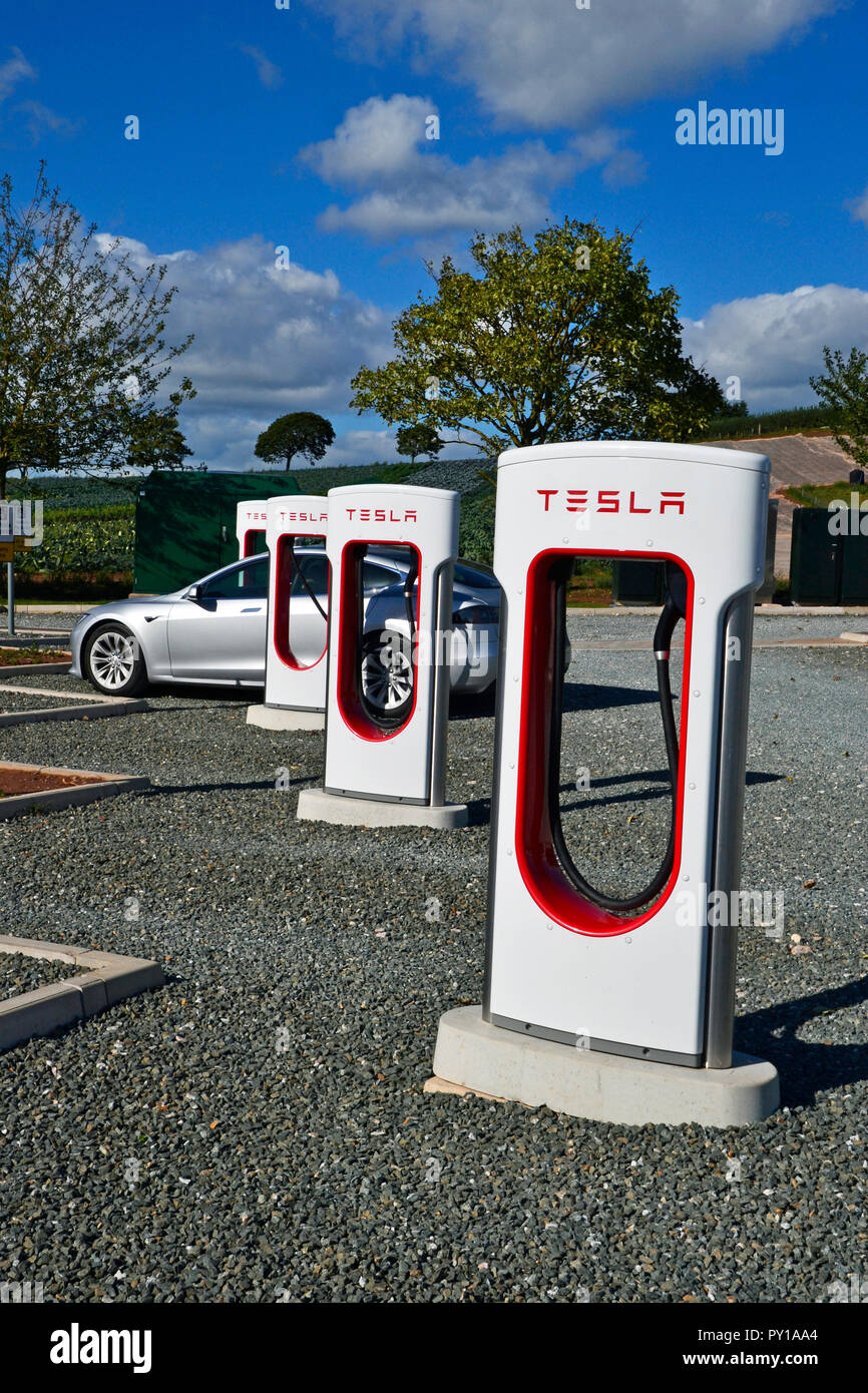 Tesla charging points for electric vehicles at Darts Farm, Exeter, Devon UK Stock Photo