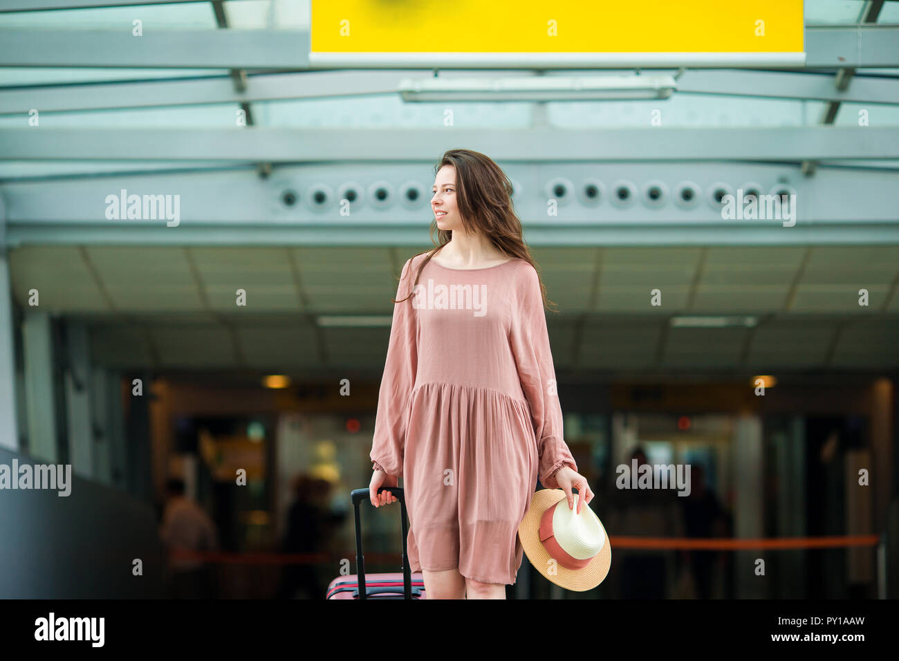 Young woman in international airport Stock Photo - Alamy